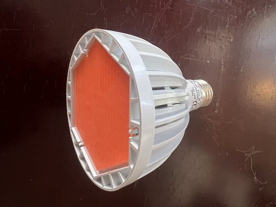Disassembled LED flood lamp showing emitter and heat sink